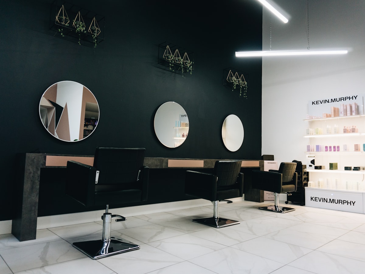 A modern boutique salon interior with styling chairs and product wall