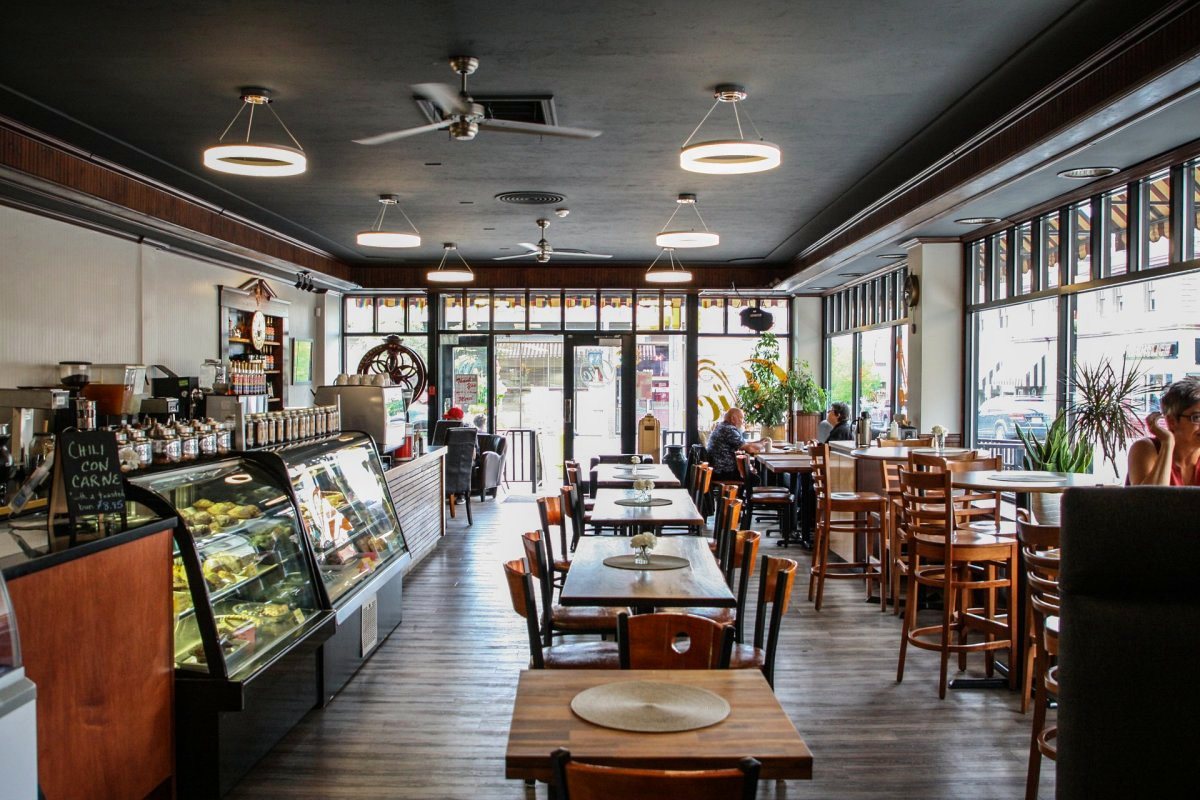 Inside The Vic Downtown — pastry case, wood tables and big street-facing windows