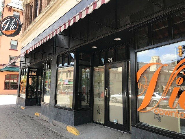 The Vic Downtown illuminated sign and striped awning