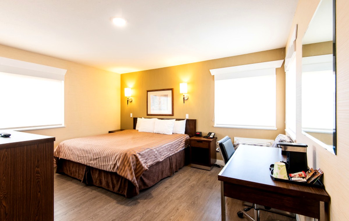 Clean, bright guest room with a king bed at Rodeway Inn & Suites Kamloops